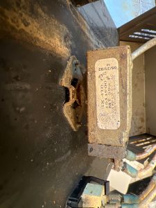 Close-up of the original faulty Garland Air Deck thermostat showing heat-stress discolouration from prolonged overheating