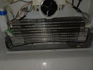 Aged copper dishwasher supply line and kinked refrigerator supply line identified during routine refrigerator service in Lincoln Park, Calgary