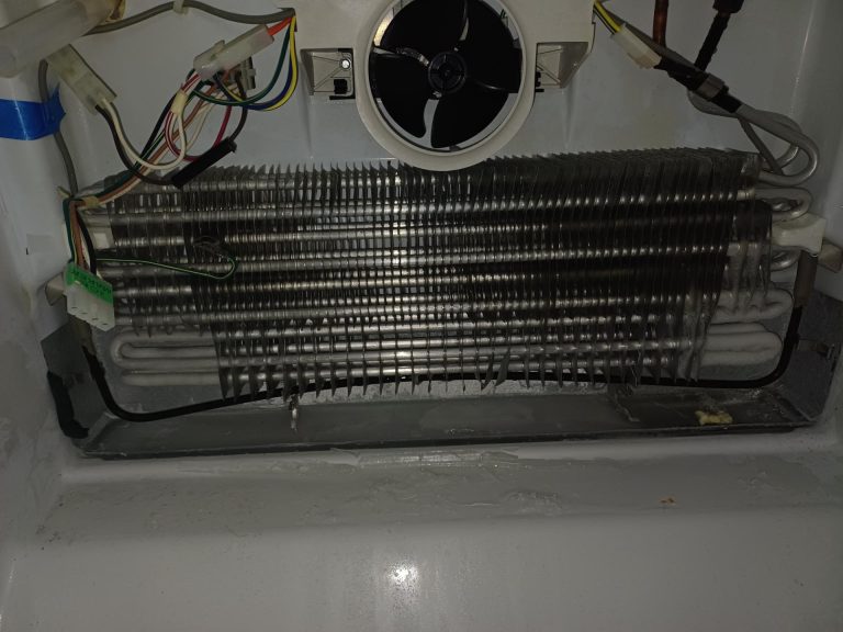 Aged copper dishwasher supply line and kinked refrigerator supply line identified during routine refrigerator service in Lincoln Park, Calgary