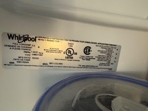 Whirlpool WRT112 top-freezer evaporator area showing ice buildup at drip tray during diagnostic in Brentwood, Calgary
