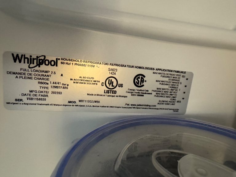 Whirlpool WRT112 top-freezer evaporator area showing ice buildup at drip tray during diagnostic in Brentwood, Calgary