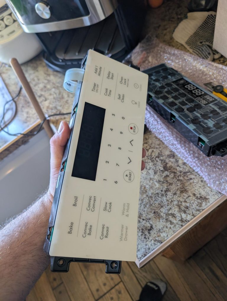 Removed control panel from a Kenmore 970-series electric range with replacement relay board ready for installation in Charleswood, Calgary
