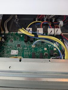 Bosch control module and harness wiring exposed during live-load diagnostic on an HBL8451UC01 wall oven in Oakmont, St. Albert