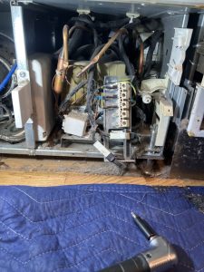 Open compressor compartment of a Thermador built-in freezer column during sealed-system diagnosis in Bayview, Calgary