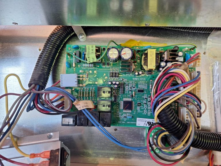 New control board installed and wired in the machine compartment of a GE Monogram 48-inch built-in refrigerator