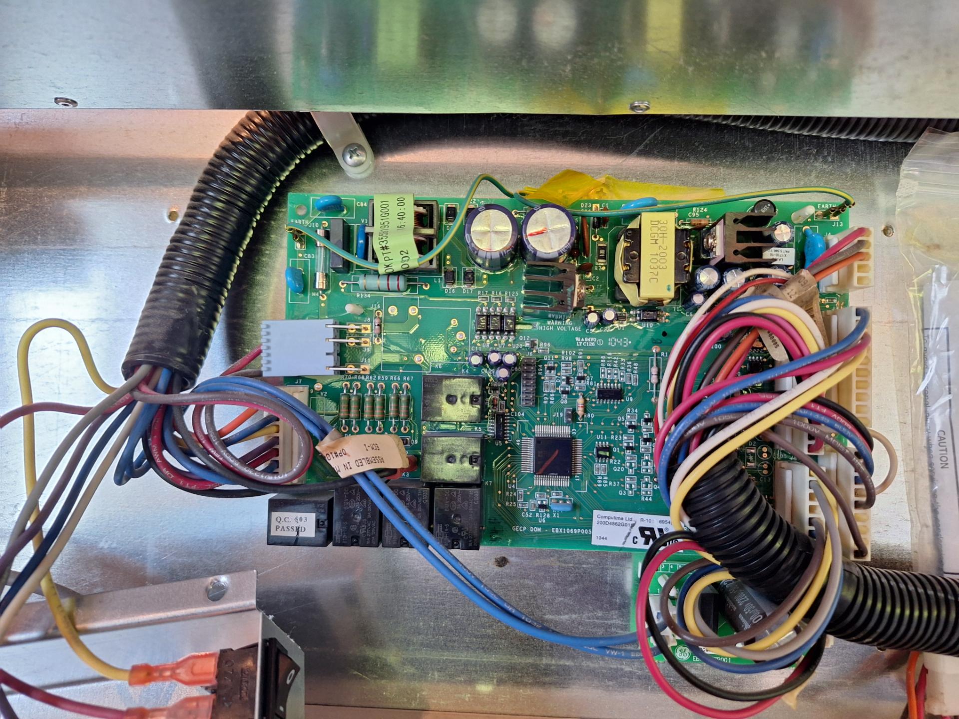New control board installed and wired in the machine compartment of a GE Monogram 48-inch built-in refrigerator