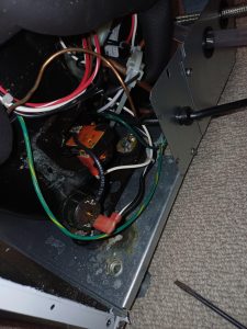 Close-up of the Scotsman ice maker internal wiring, start components and red wire-nut connections where a TechVill technician measured voltage and tested the compressor start circuit