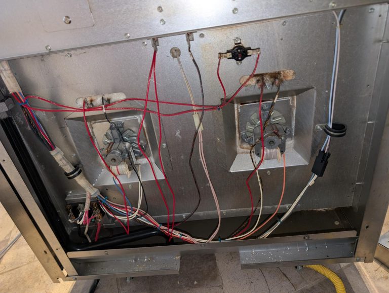 Rear access to a Wolf built-in oven for diagnostic testing of the heating circuit in Silver Springs, NW Calgary
