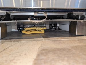 Pre-existing damage to the feet riser system on a Wolf oven in Silver Springs, NW Calgary, documented as part of the diagnostic report