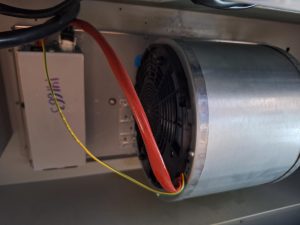 TechVill technician inspecting the wiring and start capacitor on a KitchenAid range hood blower motor in Lake Bonavista, Calgary
