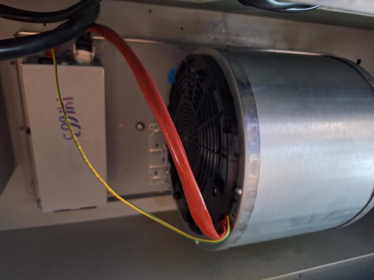 TechVill technician inspecting the wiring and start capacitor on a KitchenAid range hood blower motor in Lake Bonavista, Calgary