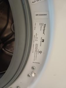 TechVill technicians inspecting the drain pump and pipe routing on a Whirlpool WSC7500VW top-load washer in Brentwood, NW Calgary
