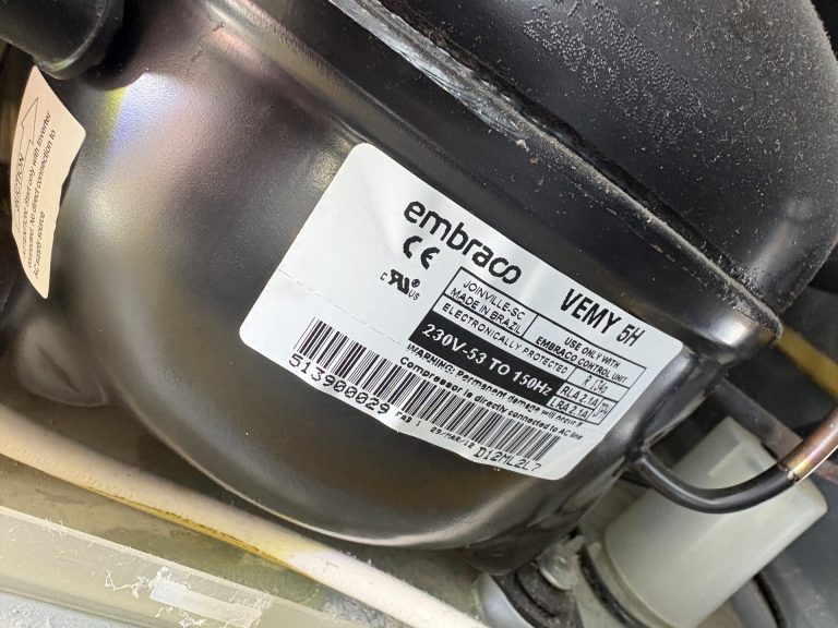 Sealed-system compressor inspection on a Miele KF1911Vi built-in refrigerator during a TechVill rural service call in Priddis, Foothills County