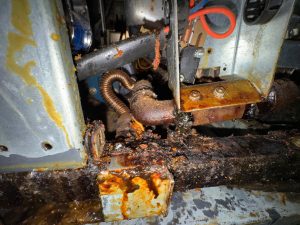 Gas plumbing and burner components of a commercial fryer under heavy grease contamination during safety diagnosis