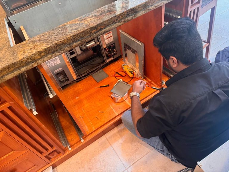 Cabinet insert built around the Miele DA6490 downdraft motor casing, blocking technician access to the harness install location