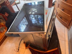 TechVill technician accessing the Miele DA6490 countertop downdraft control compartment in a British Properties kitchen, West Vancouver