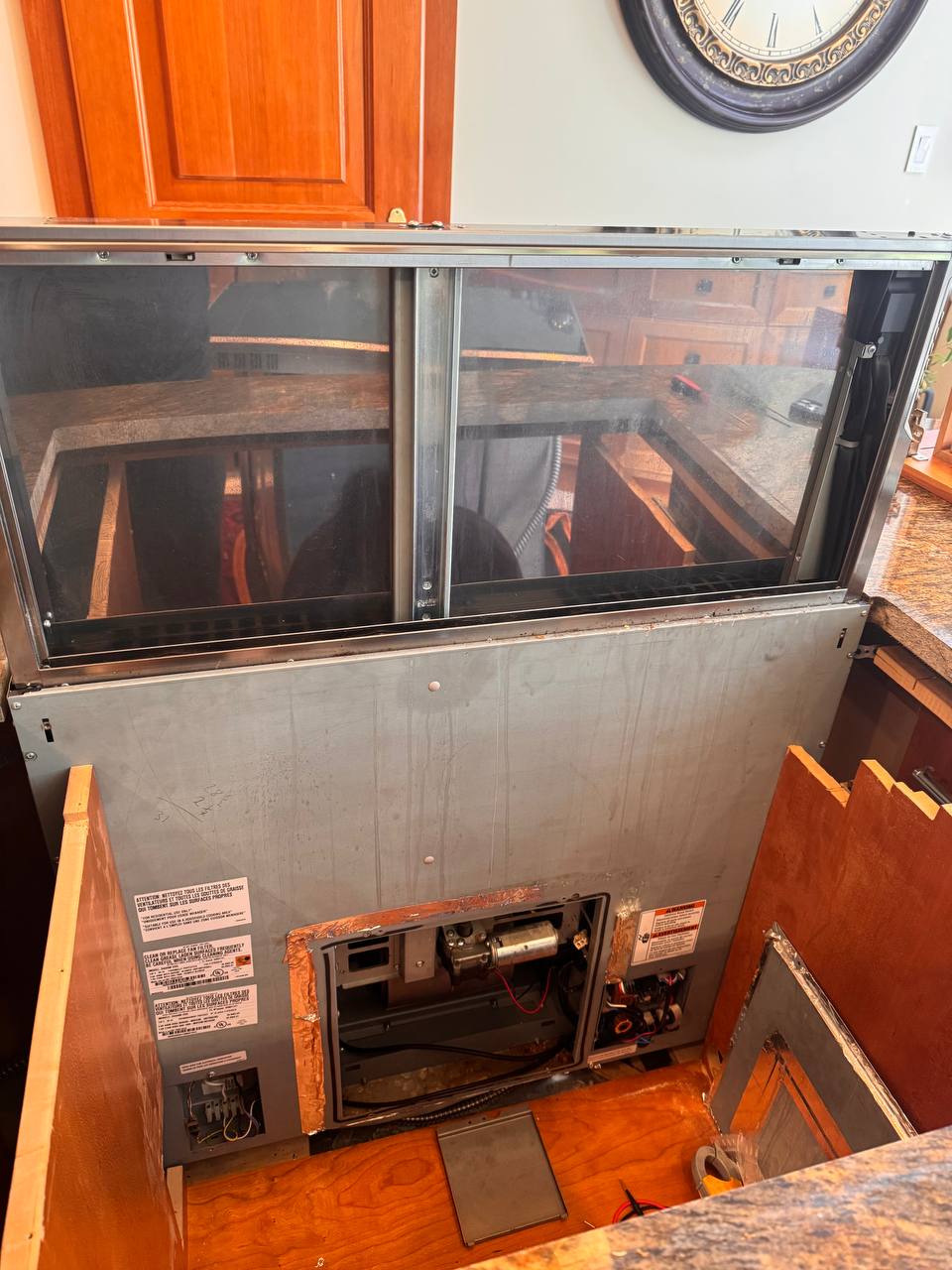 Partial access to the Miele DA6490 downdraft lift mechanism, with cabinetry obstructing the route to the motor casing