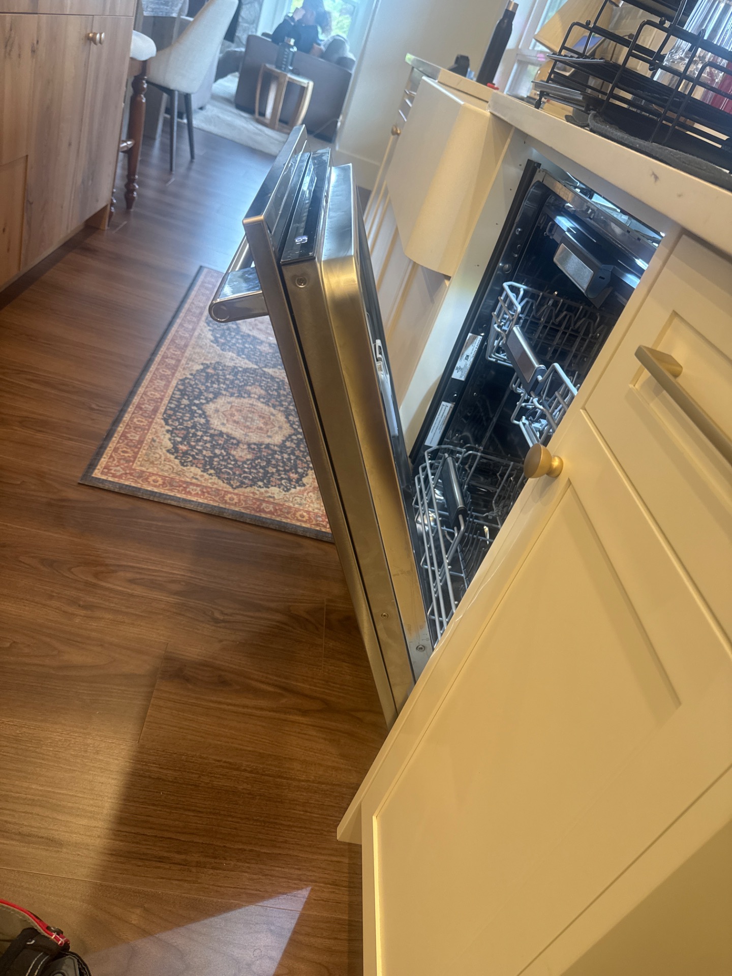 Fisher & Paykel DW24U6I1 dishwasher door open showing the front panel and door skin during panel remounting in Burnaby
