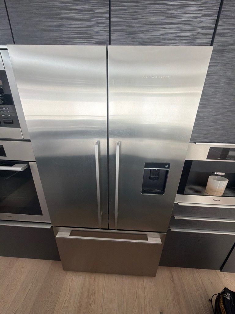 Fisher & Paykel RF201ADUSX5n stainless steel French-door refrigerator with a through-the-door ice and water dispenser, installed in a Tuscany kitchen in NW Calgary