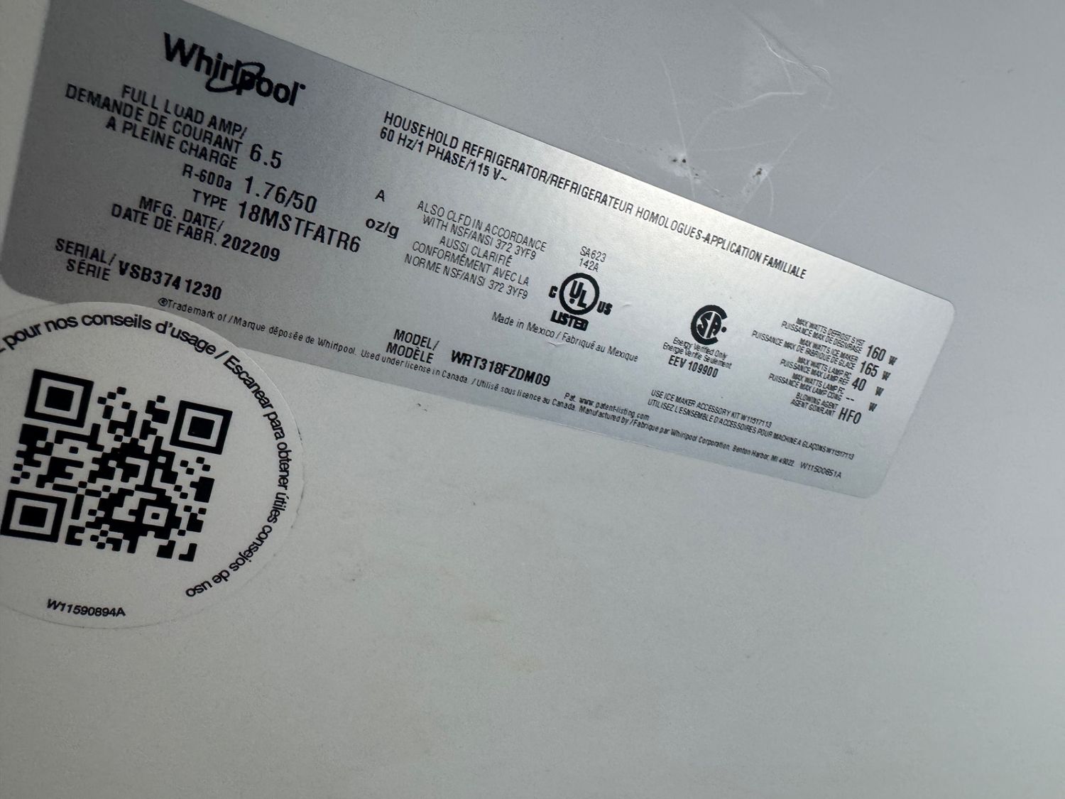 Whirlpool refrigerator nameplate confirming model WRT318FZDM09 during the diagnosis in Carrington, Calgary