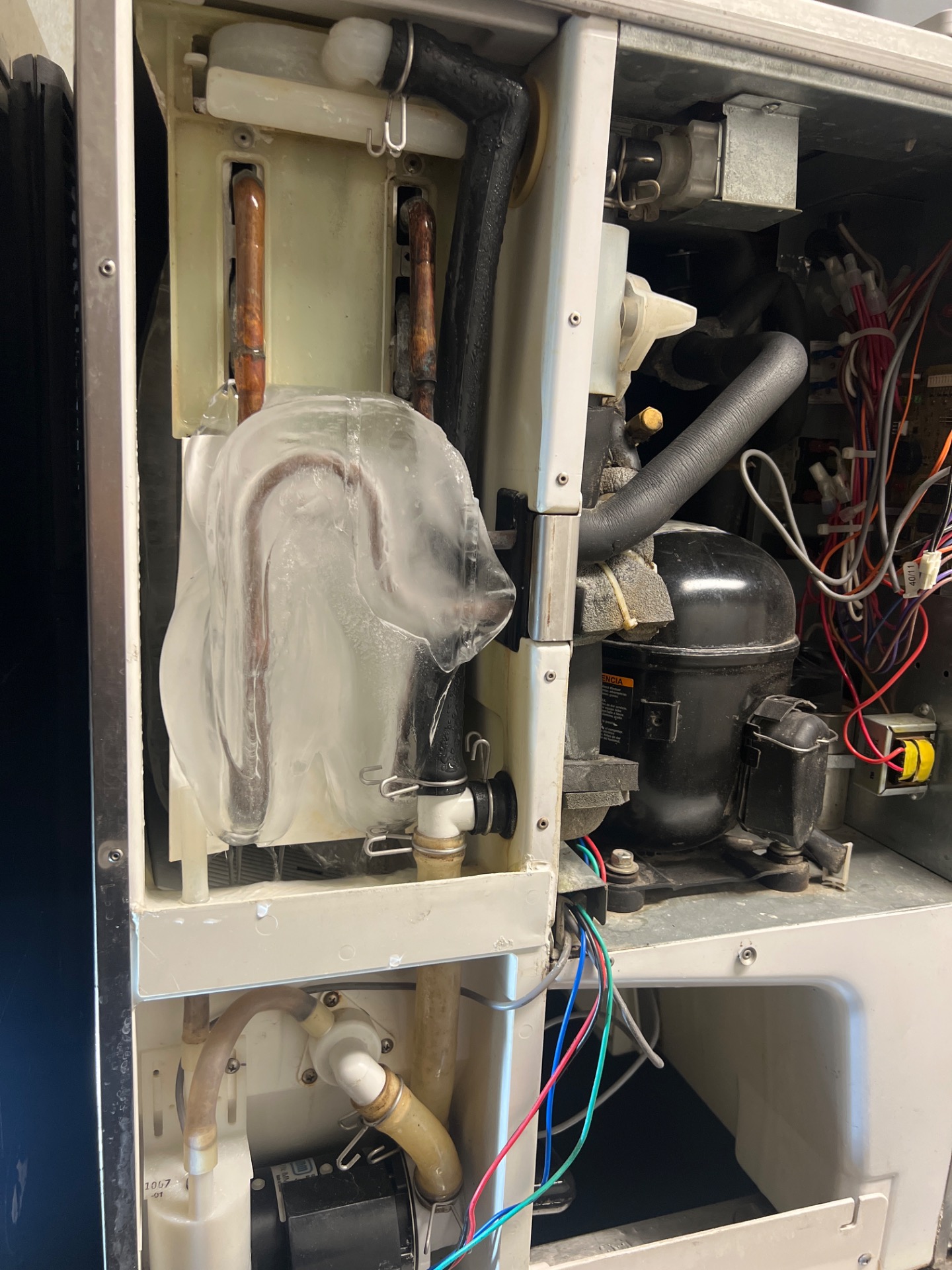 Clearing calcium buildup from the water inlet of a Hoshizaki commercial ice maker in SE Calgary