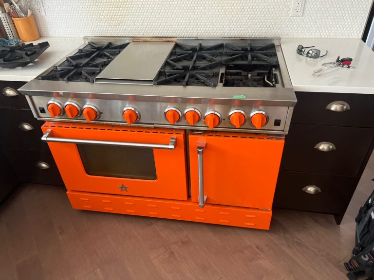 TechVill technician replacing a front burner gas valve on a BlueStar 48-inch gas range in Calgary