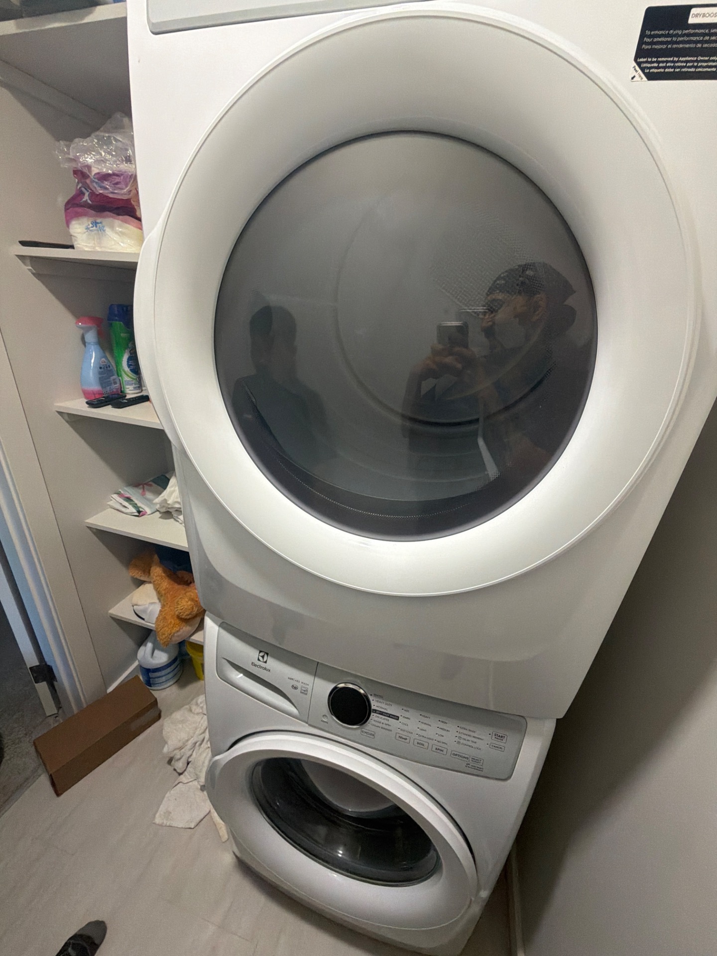 Stacked Electrolux washer and dryer in a Livingston, Calgary laundry closet, with the washer mounted below the dryer ahead of drain pump service by TechVill.