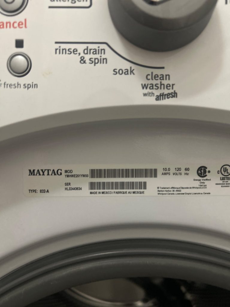 Maytag front-load washer control panel and nameplate showing model YMHWE201YW00 during the FE32 diagnosis in East Village, Calgary