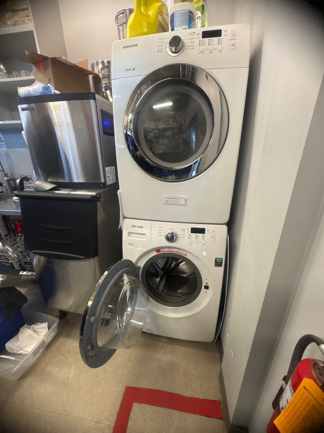 Samsung front-load washer with the door open during diagnosis at a property near the Calgary airport