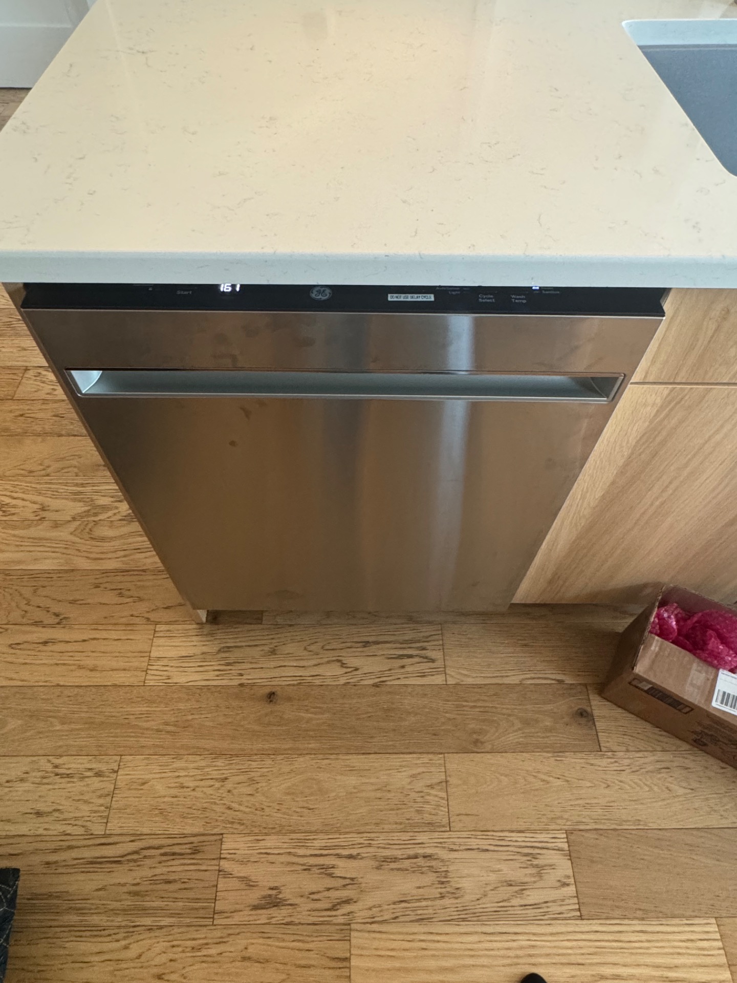 Repaired GE dishwasher powered on and running a test cycle after wash pump replacement in Central Canmore, AB