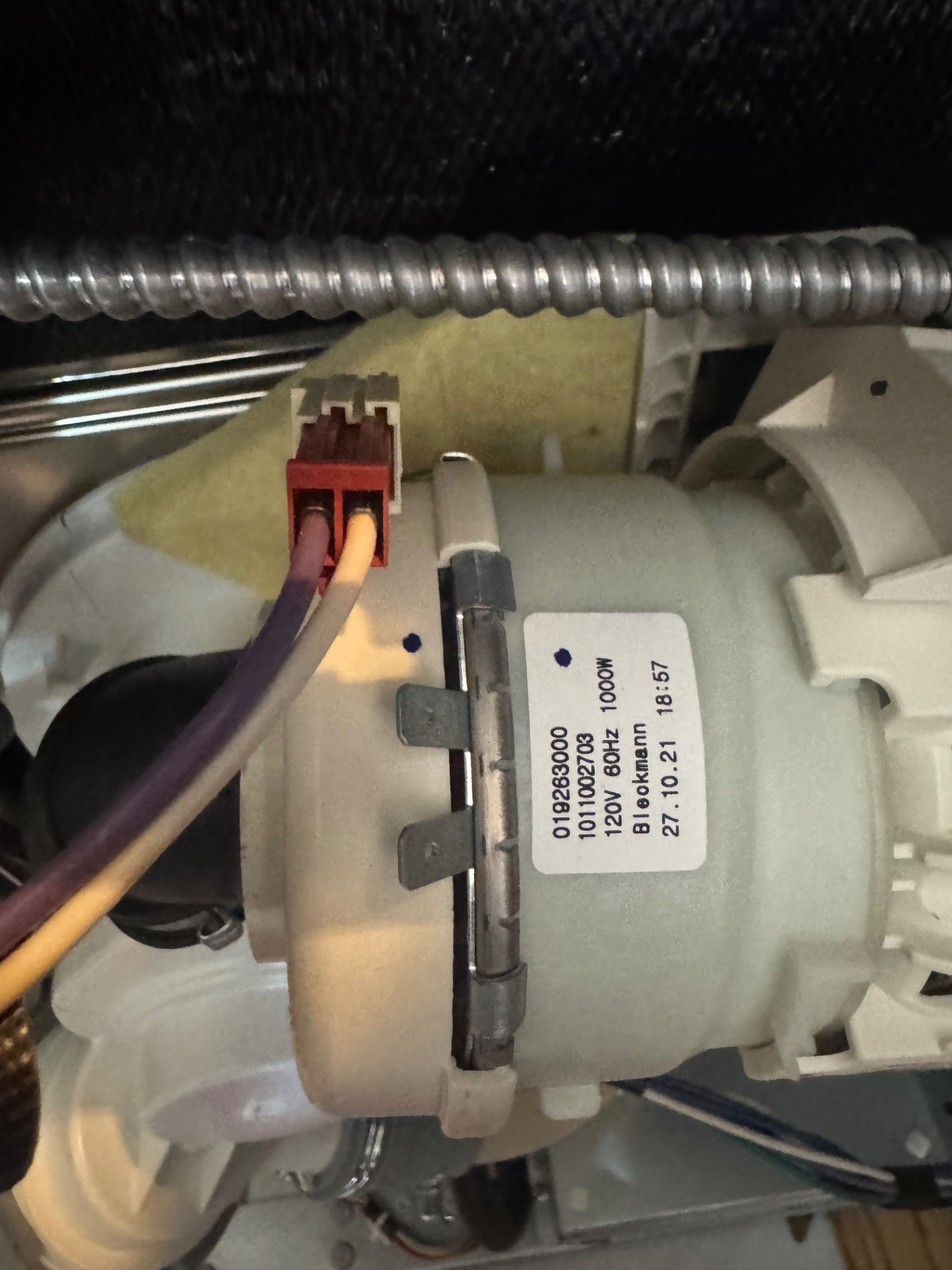 New GE wash pump assembly with wiring connected during a dishwasher repair in Central Canmore, AB