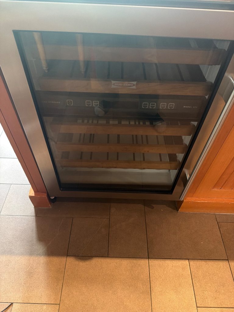 Sub-Zero built-in wine refrigerator model 424 running warm in a Canmore, AB kitchen before TechVill sealed-system repair