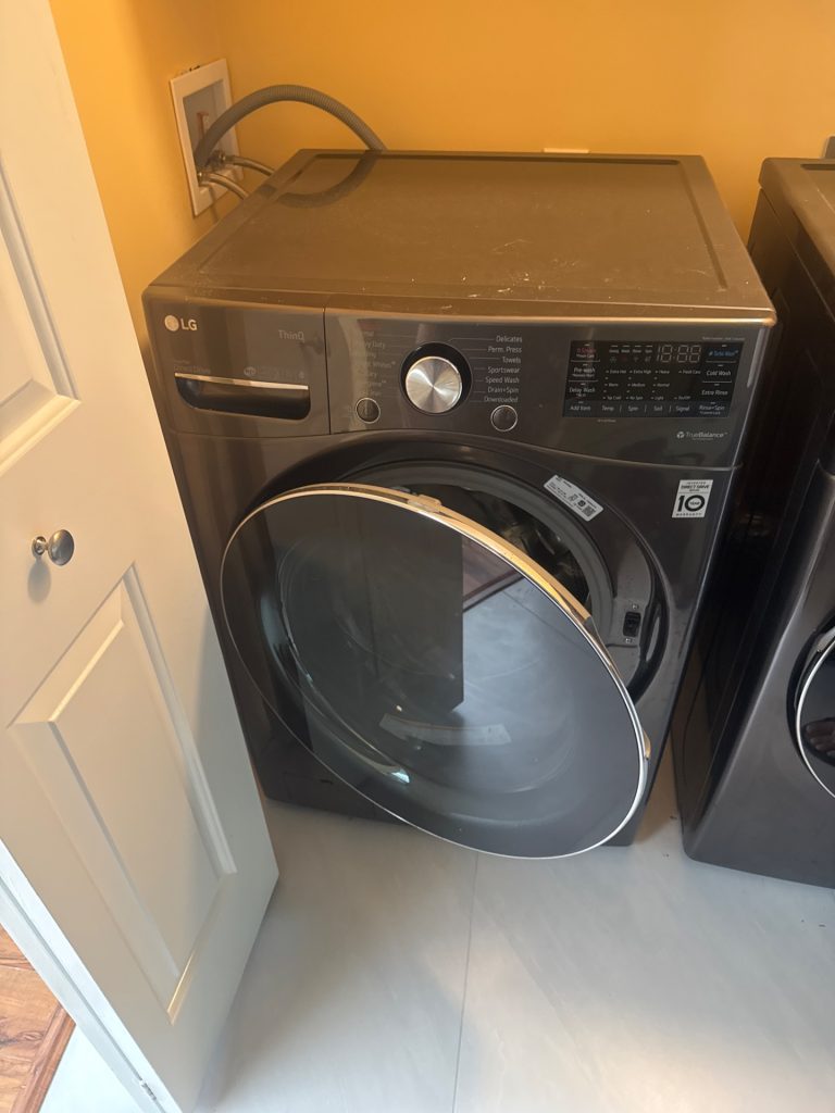 LG WM4100HBA black-stainless front-load washing machine installed in a North Delta, BC laundry area, the appliance TechVill inspected for a door leak