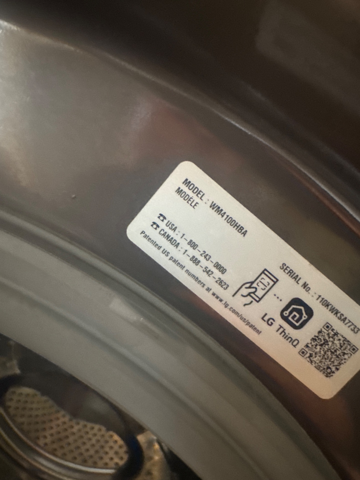 Close-up of the LG WM4100HBA model and serial rating label read on site to source the correct OEM door gasket for this washer configuration