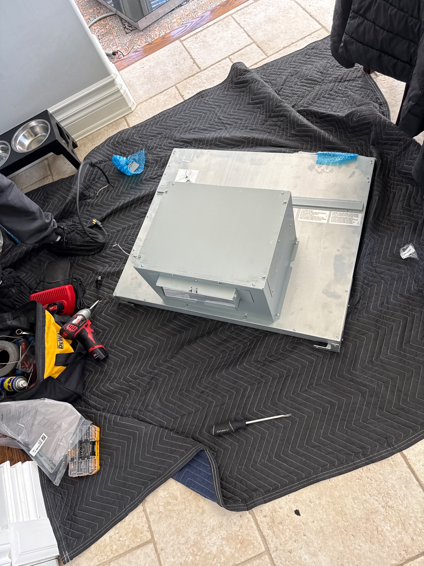 Checking the fit of a new KitchenAid downdraft unit against the countertop cutout in Ottawa
