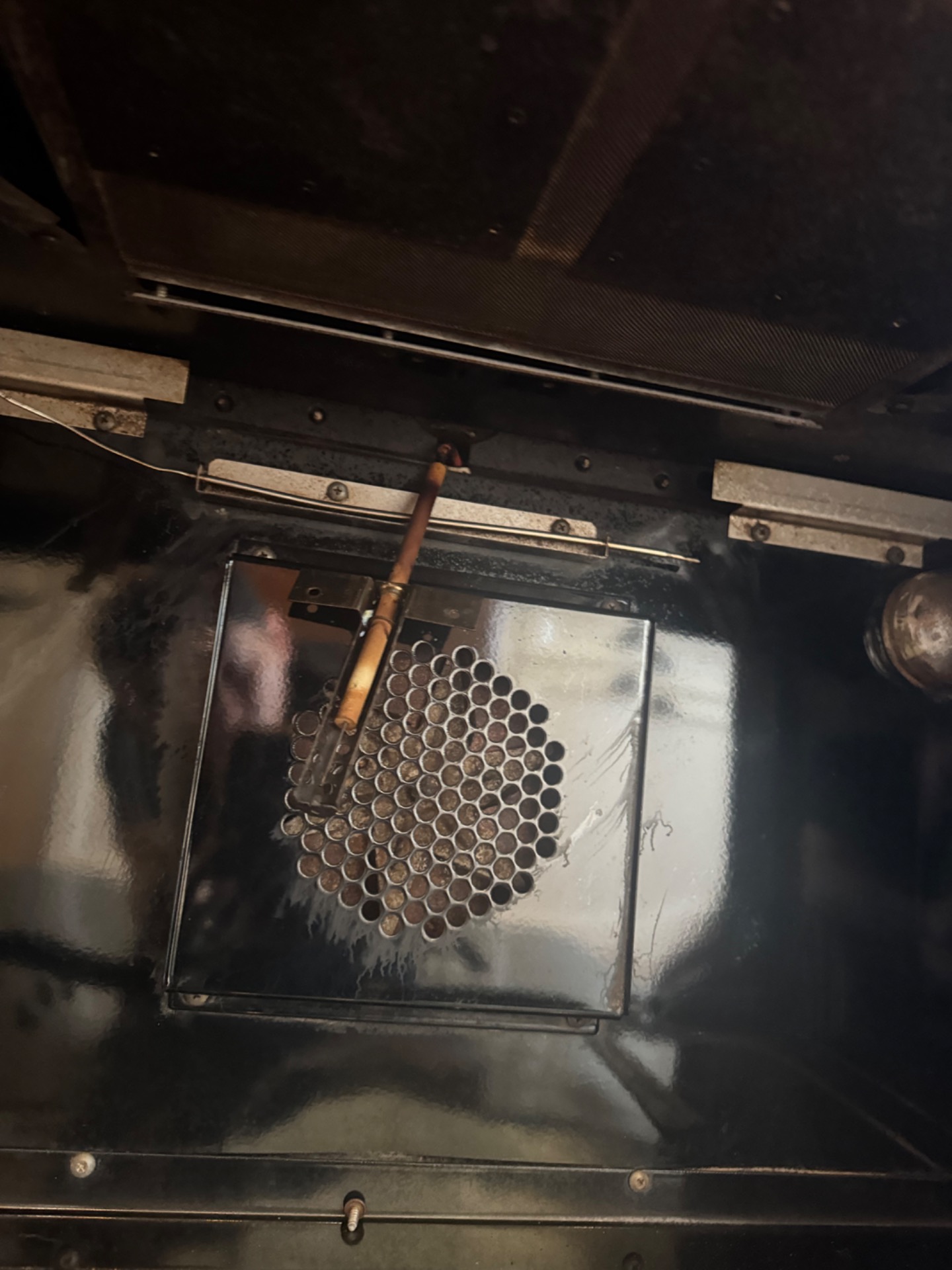 Wolf gas range oven interior showing the broil burner and worn broil igniter during diagnosis by TechVill