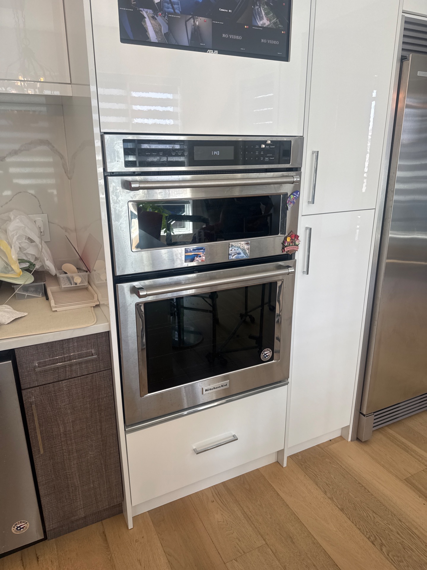 KitchenAid combination wall oven and microwave built into white cabinetry in a South Surrey, BC kitchen