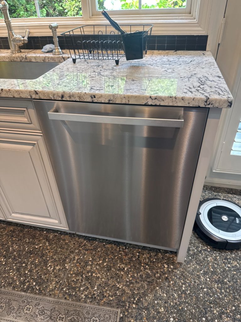 Fully integrated Miele stainless steel dishwasher installed under a granite countertop in a Shaughnessy, Vancouver kitchen before repair