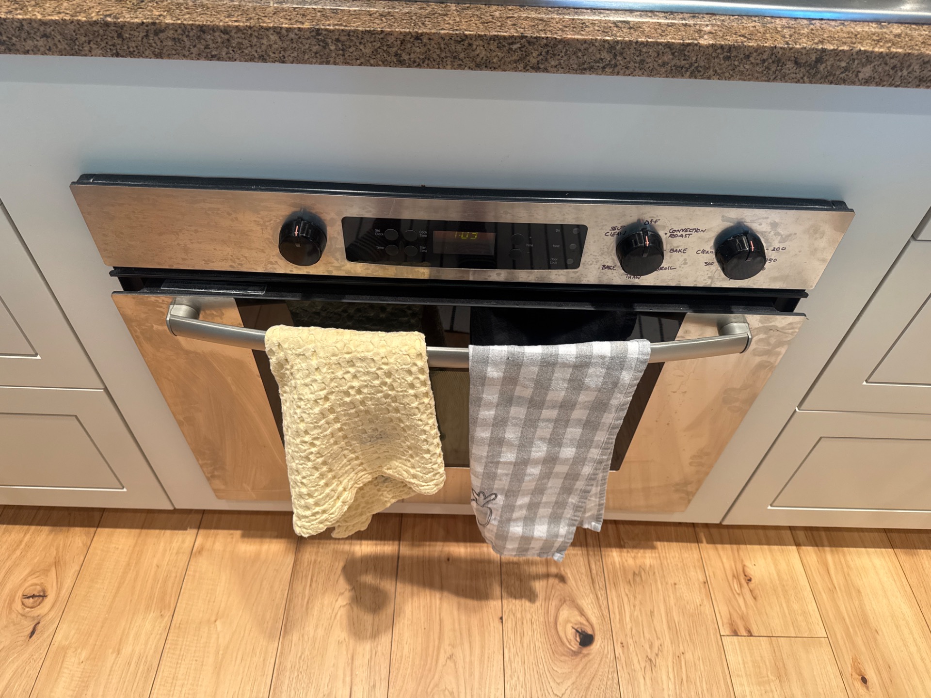 TechVill technician diagnosing a Bosch wall oven door that won't close in Yaletown Vancouver