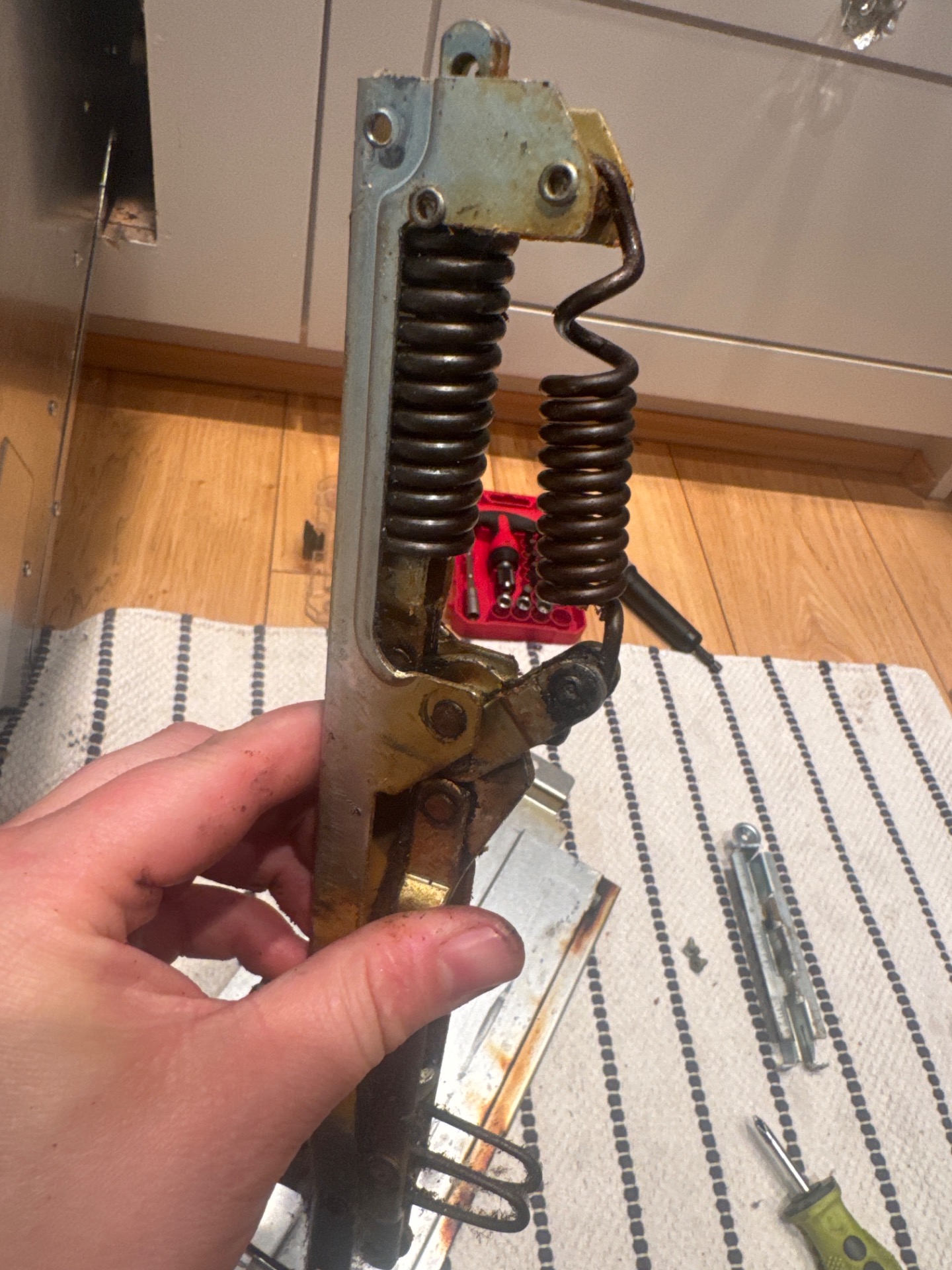 Reforming and reassembling the hinges on a discontinued Bosch wall oven in Vancouver
