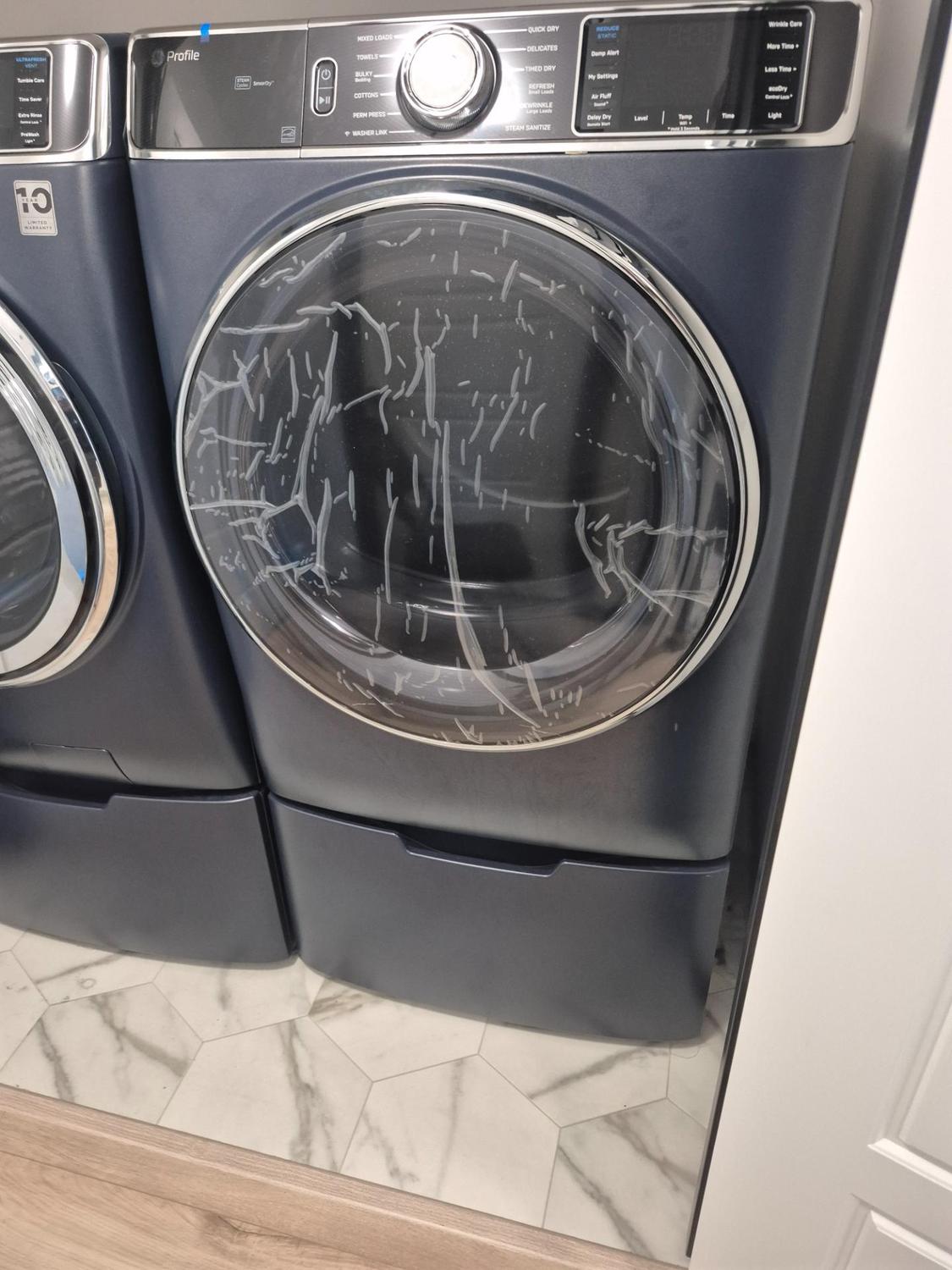 GE Profile washer and dryer pair in a NW Winnipeg laundry room before the dryer diagnosis