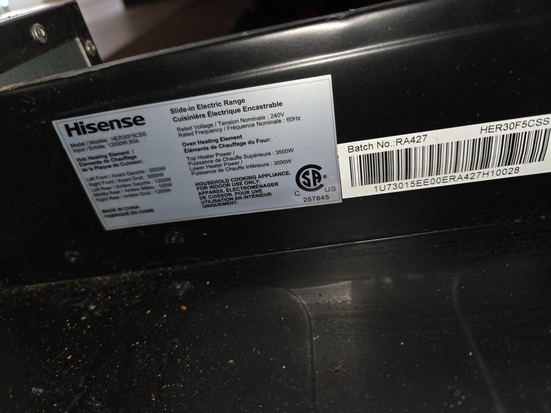 TechVill technician diagnosing the oven controls on a Hisense electric range in Sage Creek Winnipeg