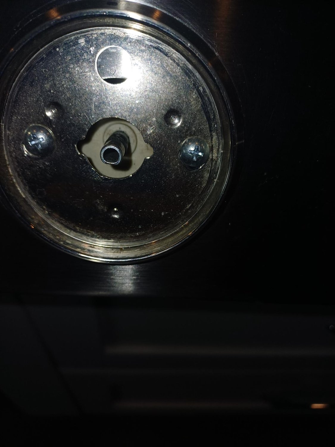 Burner igniter mounting inspected from below during the Electrolux ICON cooktop service