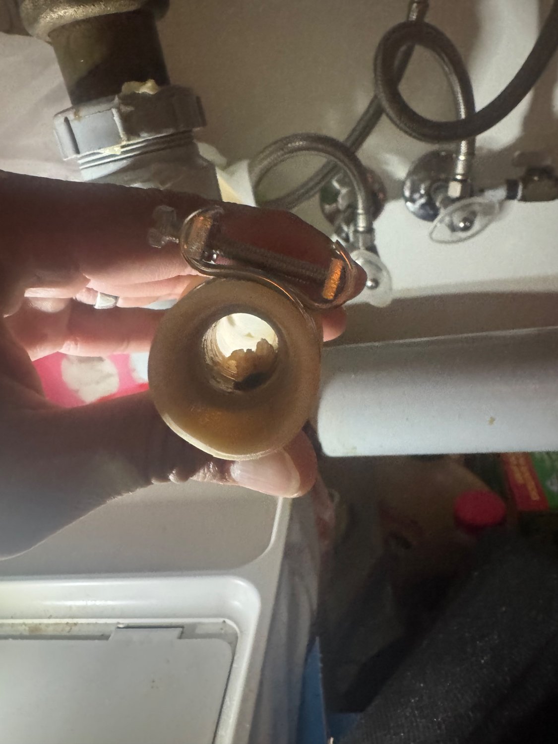 Drain hose fitting removed under the sink showing the buildup that blocked the Bosch dishwasher's outflow?