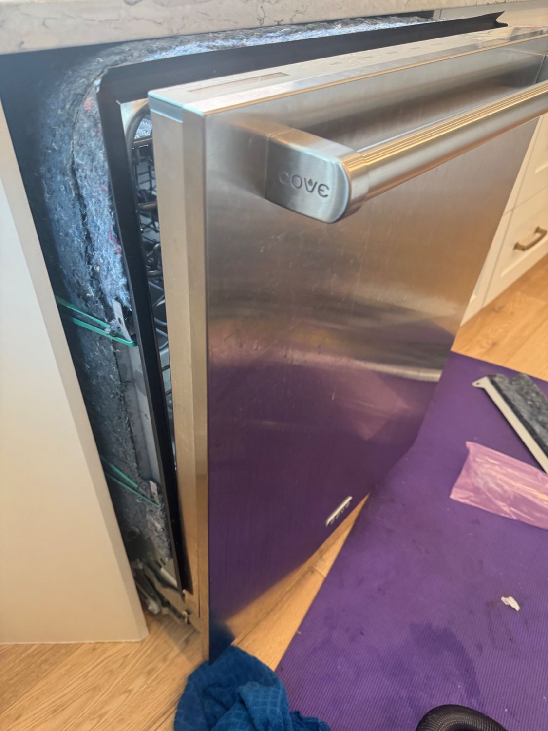 Cove-branded handle on a panel-ready built-in dishwasher at a Church Ranches home near Calgary