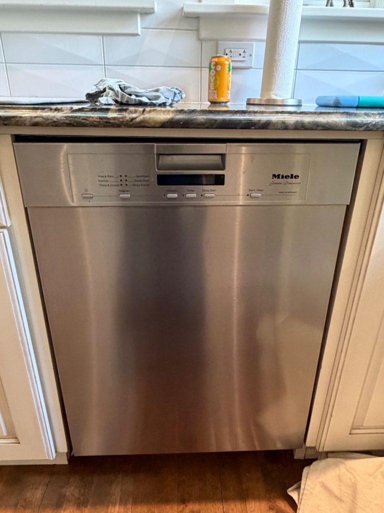 Miele Futura Dimension built-in dishwasher in a Bankview, Calgary kitchen before the follow-up repair visit