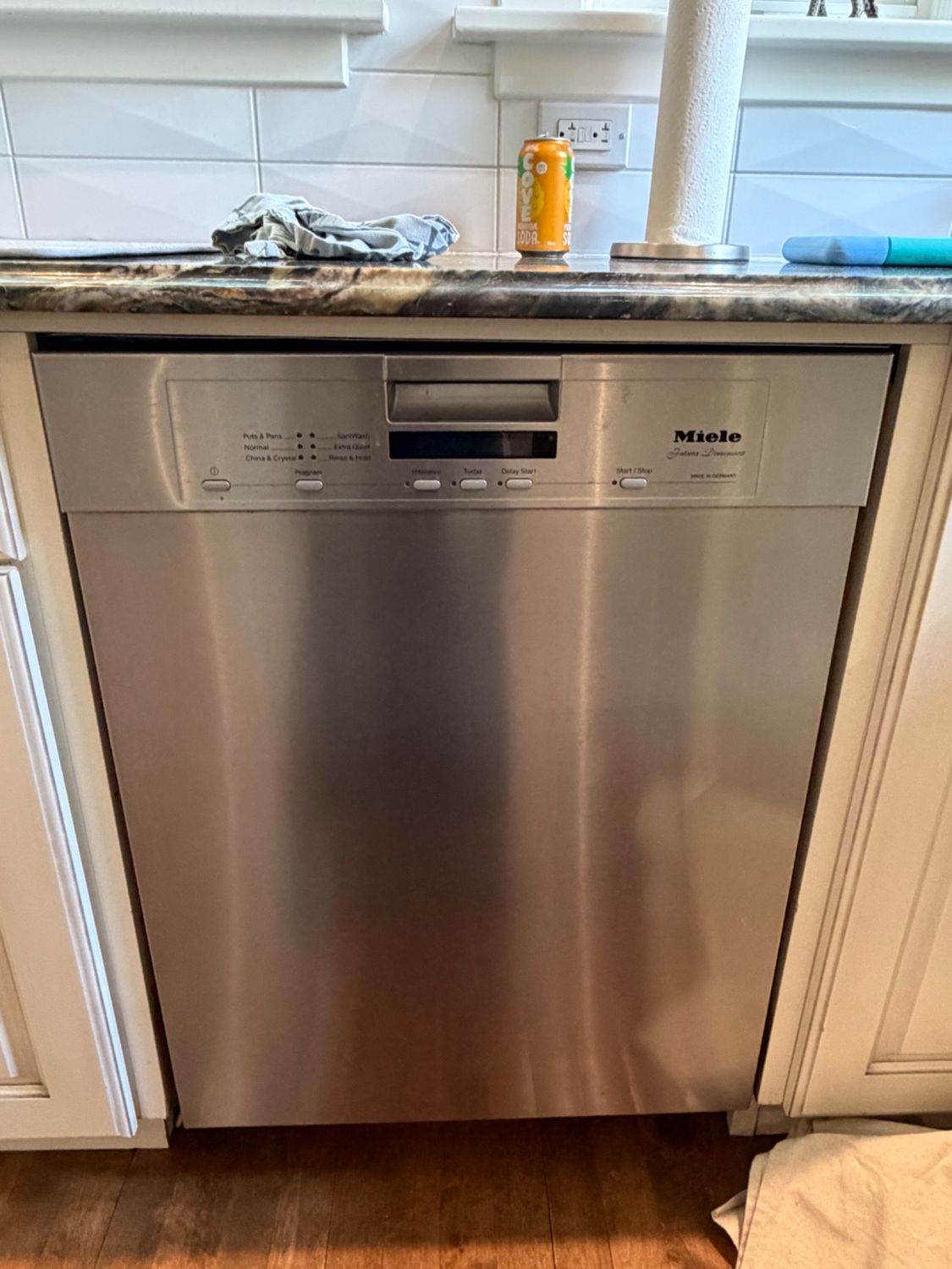 Miele Futura Dimension built-in dishwasher in a Bankview, Calgary kitchen before the follow-up repair visit