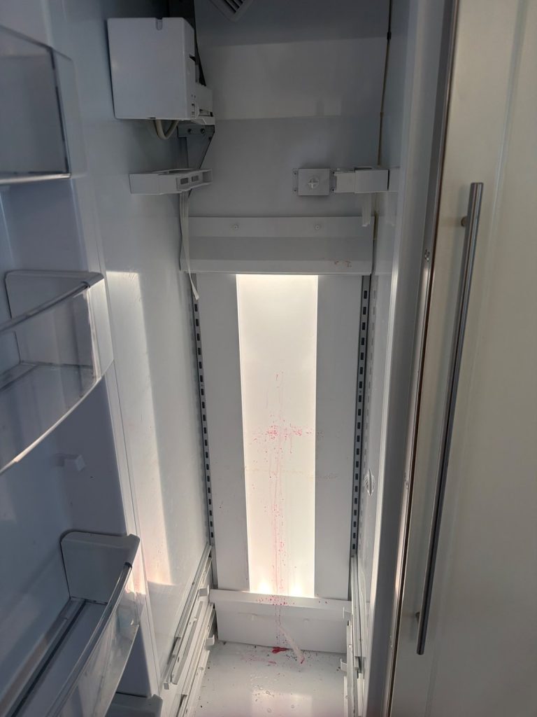 Interior of the 12-year-old GE built-in refrigerator column during TechVill's evaporator inspection in Wildwood, Calgary