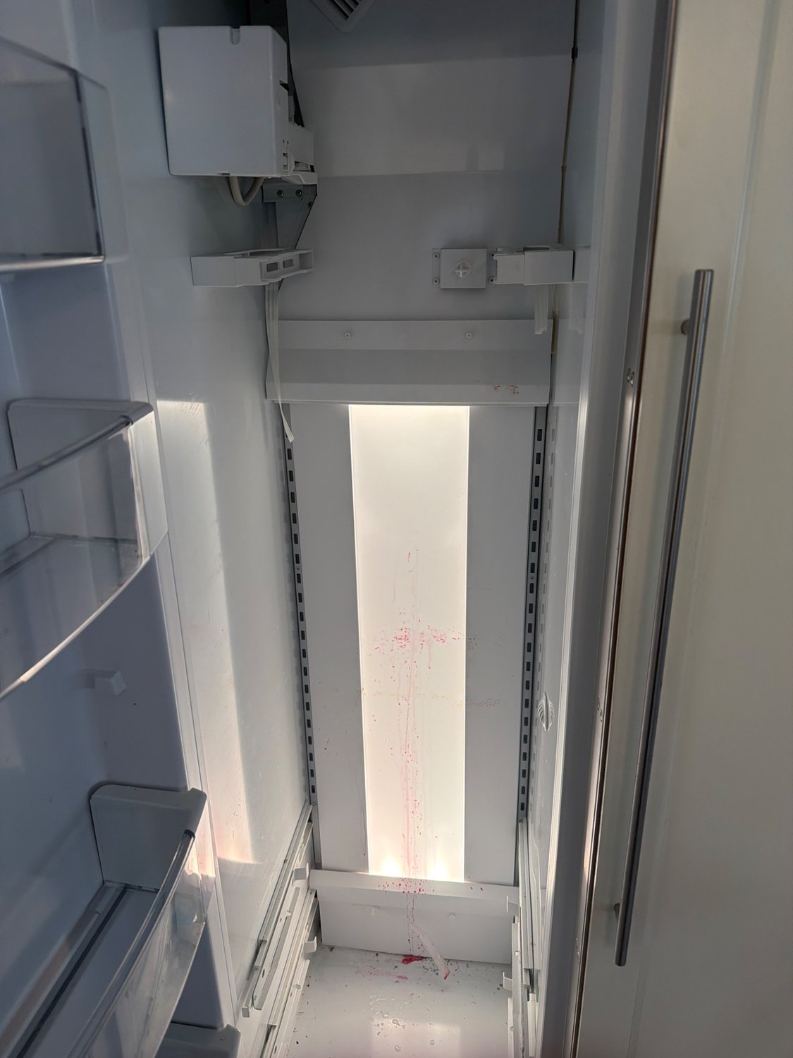 Interior of the 12-year-old GE built-in refrigerator column during TechVill's evaporator inspection in Wildwood, Calgary