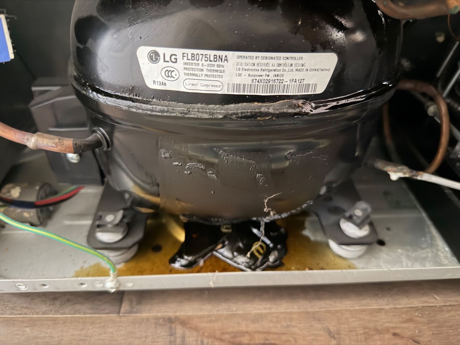 LG linear inverter compressor inspected in the machine compartment during a TechVill sealed-system diagnostic